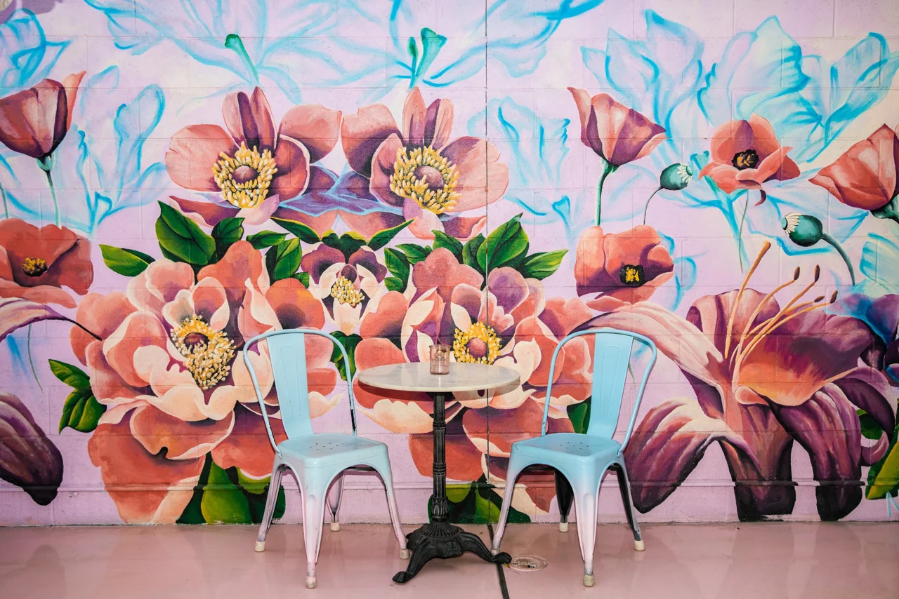 A colorful mural and patio seating at Velveteen Rabbit